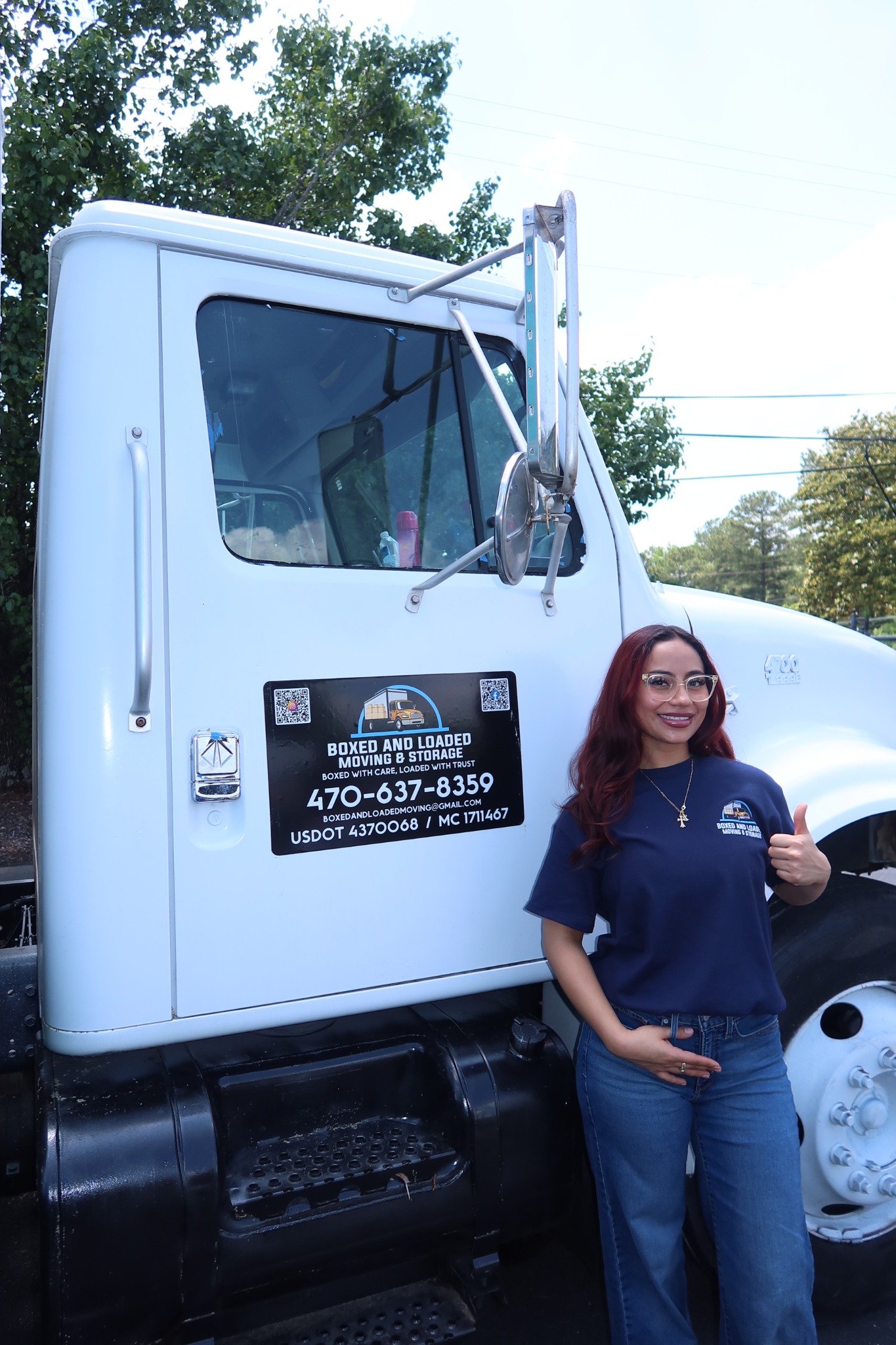 Boxed and Loaded uniformed team member with the moving truck