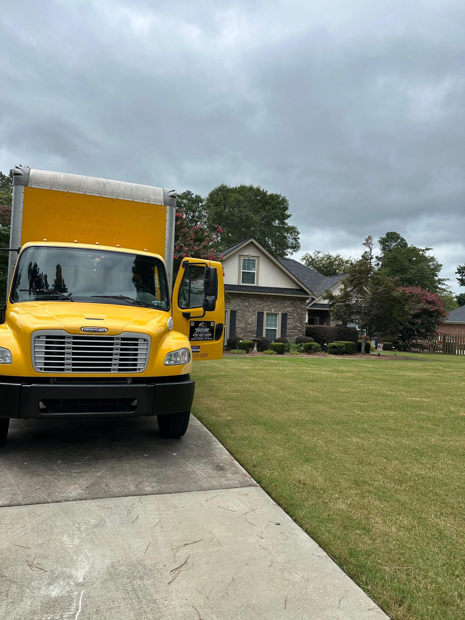 Boxed and Loaded yellow Freightliner moving truck at a residential move