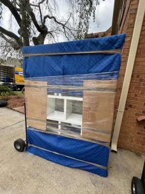 Furniture professionally wrapped with moving blankets and plastic wrap for secure transport in Alpharetta, GA